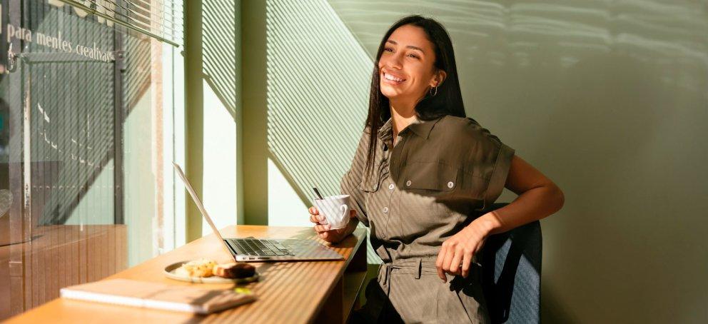 woman sitting in cafe studying for her online mba